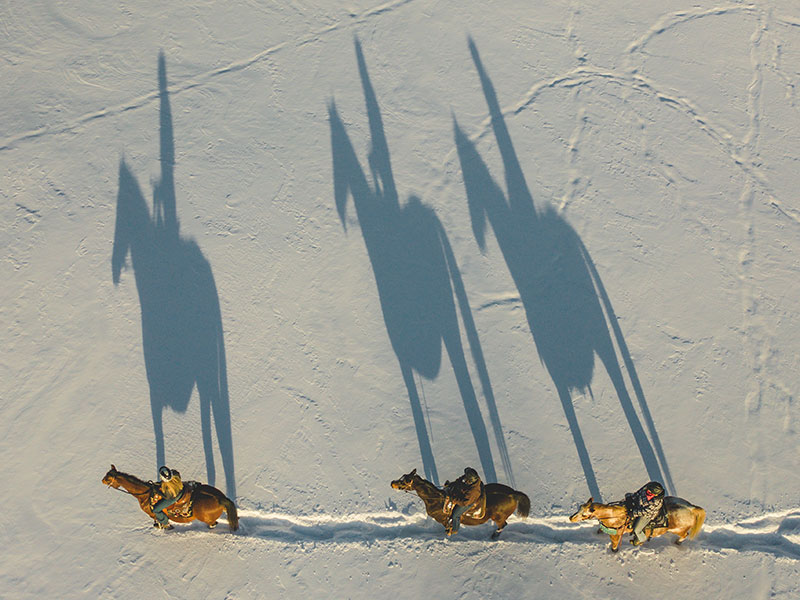 Riders in winter from above at Nation Valley Ranch in Chesterville, Ontario